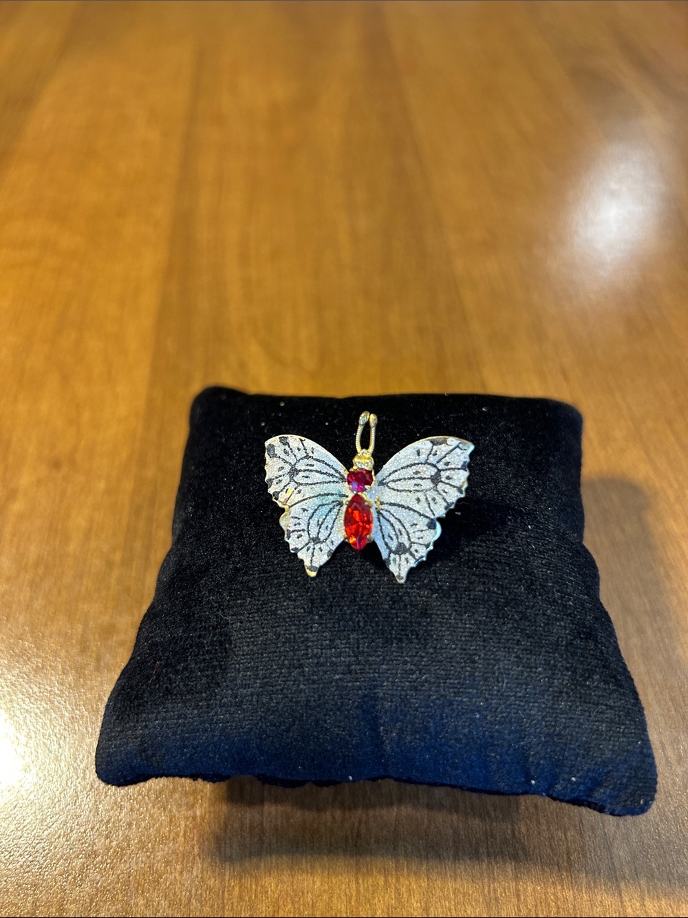 Elegant Butterfly Pendant with Red Gemstone Accent